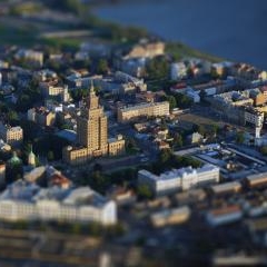 Rīgas augstceltne un apkārtējie pilsētas kvartāli aerofotogrāfijā ar miniatūras efektu.